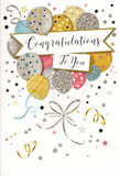 The photograph displays a sophisticated congratulations card whose design feels like a small, contained party-perfect to tuck alongside a bouquet sent to friends or family in Noak Hill. At the centre, a cluster of balloons rises gracefully, their rounded forms overlapping to create a full, three-dimensional effect. The balloons are rendered in soft, shimmering hues of gold, silver, champagne, sky blue, delicate blush pink, and gentle grey. Some balloons are sprinkled with tiny twinkling stars; others carry thin metallic stripes or areas of glitter that look as though they would feel slightly raised to the touch. From the base of the balloon cluster, thin ribbons unfurl in flowing trails of gold and silver, looping downward in loose spirals until they meet in an elegant flourish towards the bottom edge, recalling the way a florist ties off a celebratory bouquet. The background is a soft, creamy white scattered with small metallic stars, dots of confetti, and curved streamers that drift across the surface, creating the impression of festive movement-as if the scene were captured mid-celebration at a home near Romeo Corner or around the lanes of Noak Hill. Across the centre, a refined banner sweeps gently from side to side, lined with subtle metallic edging. Inside the banner, the message "Congratulations To You" appears in flowing, ornate script, conveying warmth, pride, and heartfelt admiration. The card's atmosphere is bright yet elegant, making it an ideal partner for flowers given for exam success, a promotion, a new home near Harold Hill, or any milestone where you want your congratulations to feel both joyful and beautifully presented.